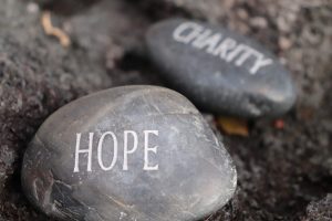 Two rocks with carvings in them. One says Hope and the other says Charity